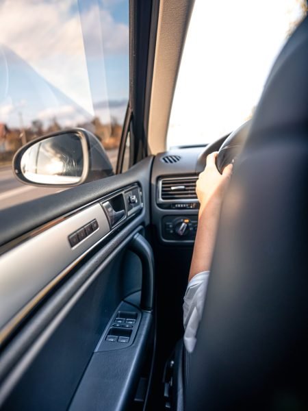 Car rear view mirror, view from inside the car, travel by personal transport.